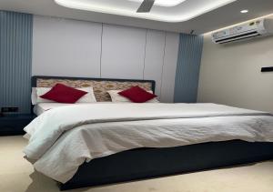 a bedroom with a large bed with red pillows at Hotel Royal Plaza in Phulabāni +8 photos