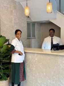 a man and a woman standing in front of a counter at The Ketan in Pune