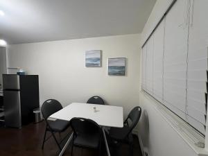 an office with a white table and black chairs at Chapman H in Toronto +4 photos