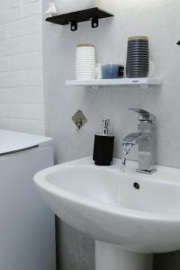 a bathroom with a sink and a toilet and a faucet at luxury house in Ierapetra +23 photos
