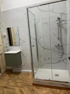 een badkamer met een glazen douche met wastafel bij B&B Valencia in Valencia