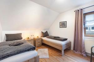een slaapkamer met twee bedden en een raam bij Ferienwohnung Grobbel in Schmallenberg