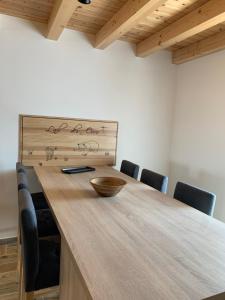a dining room with a wooden table and chairs at L'Ail des Ours in Les Estables +4 photos