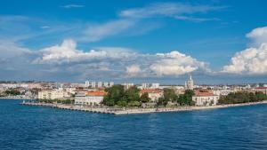 a group of buildings on an island in the water at Villa Kunta by Villas Guide in Gornja Jagodnja