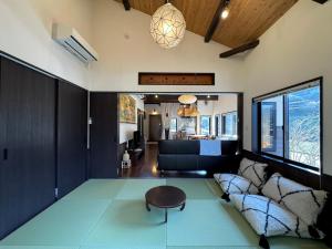 a living room with a table and a couch at IMARI HOUSE shachihoko イマリハウス しゃちほこ in Imari