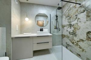 a bathroom with a sink and a mirror at RentPlanet - Apartamenty IzerSKI Resort in Świeradów-Zdrój +231 photos
