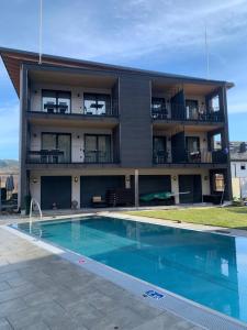 a building with a swimming pool in front of a building at Goldener Adler Oberried - Hotel & Appartements in Oberried
