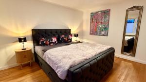 a bedroom with a large bed and a mirror at Sylter Seestern App Ankerplatz in Morsum +17 photos