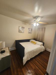 een slaapkamer met een bed en een plafondventilator bij Lansdowne Gem in Lansdowne