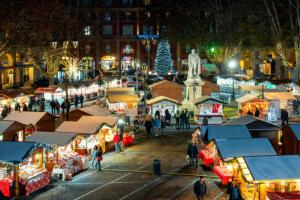 a christmas market in a city at night at Casa LOUES in Asti +4 photos