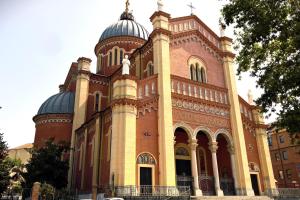 a large brick building with domes on top of it at Casa LOUES in Asti
