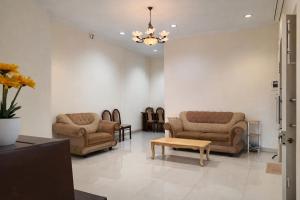 ABC Homestay في Sentool: غرفة معيشة مع أريكتين وطاولة