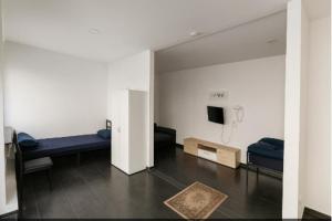 a room with two beds and a tv in it at Marie Zimmer Zentral Günstig in Heilbronn