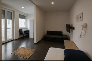 a living room with a bed and a couch at Marie Zimmer Zentral Günstig in Heilbronn