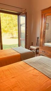 two beds in a room with a window at Pool Villa With Animals Near Sutri in Sutri +22 photos