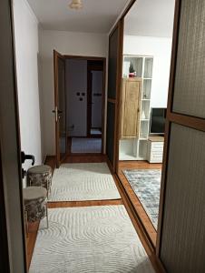 a hallway with a door open to a living room at La Montzi For4 in Craiova