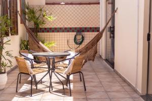 a balcony with a table and chairs on it at Recanto aconchego in Peruíbe +35 photos