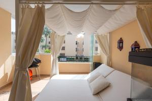 een slaapkamer met een bed en een groot raam bij Hacienda Playa in Marbella +112 foto's