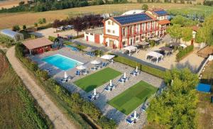 an aerial view of a house with a swimming pool at Il Poggio Agrisport in Poirino