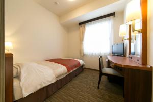 Postel nebo postele na pokoji v ubytování Hotel New Ueno
