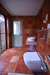 a bathroom with a toilet and a sink at Vedic Village Retreat Alleppey in Alleppey +56 photos