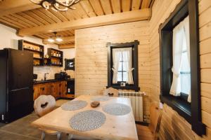 a wooden dining room with a table and chairs at Chalet De Paul in Moisei