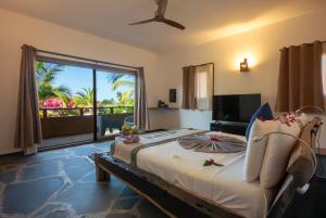 a bedroom with a bed with a view of the ocean at Di Milo Boutique Hotel in Kiwengwa