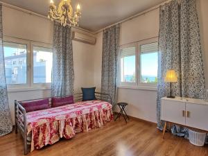a bedroom with a bed and two windows at Apartment Wunderschöner Paço D'Arcos by Interhome in Paço de Arcos