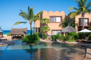 a resort with a swimming pool in front of the ocean at Di Milo Boutique Hotel in Kiwengwa
