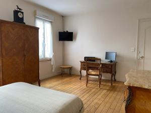 een slaapkamer met een bureau, een computer en een bed bij Le rêve de Jocelyne - Grande maison au Neubourg in Le Neubourg