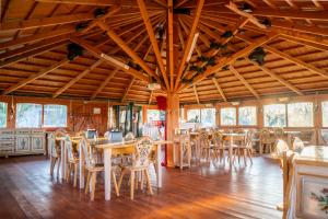a dining room with wooden tables and chairs at Acacia Village in Ogrezeni