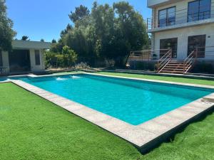 a swimming pool in front of a house at Home Quillon in Quillón