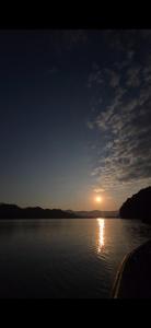 a sunset over a large body of water at Glamping Begnas in Deorāli