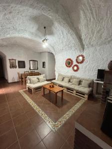 a living room with a couch and a table at Bike Cueva - Los Coloraos in Gorafe