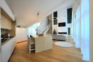 a kitchen and living room with a table and a couch at The Rock in Sinaia