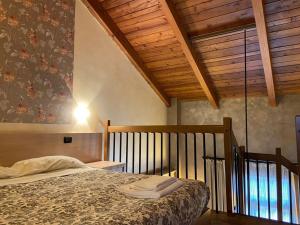 a bedroom with a bed and a wooden ceiling at Il Poggio Agrisport in Poirino +55 photos