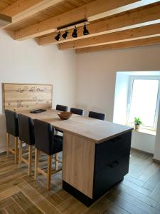 a kitchen with a large wooden table and chairs at L'Ail des Ours in Les Estables