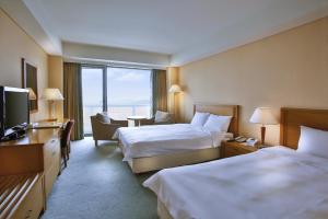 Gulta vai gultas numurā naktsmītnē Hotel Hyundai by Lahan Mokpo