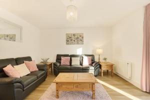 a living room with two couches and a coffee table at Yeavering - North East Escapes in Wooler +13 photos