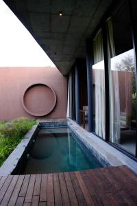 a swimming pool in the middle of a house at Ayana Villa By KPM in Varagampadi