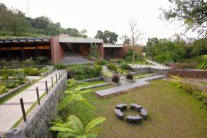 a garden in front of a building at Ayana Villa By KPM in Varagampadi
