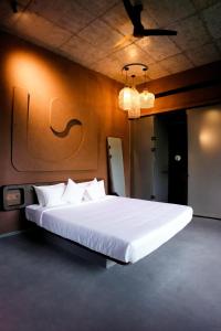 a bedroom with a large white bed in a room at Ayana Villa By KPM in Varagampadi +53 photos