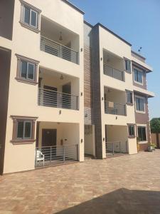 a large white building with a patio in front of it at Property for rent in Accra