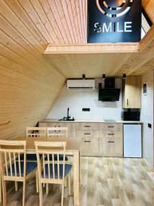 a kitchen with a table and chairs and a sink at smile cottage in Borjomi
