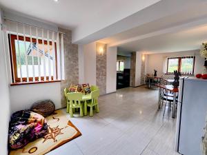 a living room with a kitchen and a dining room at Ośrodek Wypoczynkowy Baca in Poronin