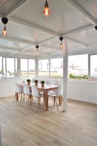 a dining room with a table and white chairs at La Isleta Nest Hostel in Las Palmas de Gran Canaria +15 photos