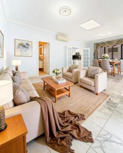 a living room with a couch and a table at Burwood central home in Sydney