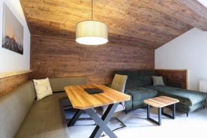 een woonkamer met een bank en een tafel bij Appartements Alpenland in Lermoos
