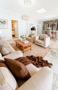 a living room with couches and a coffee table at Burwood central home in Sydney