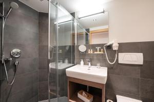 a bathroom with a sink and a shower at Haus Iris in Lech am Arlberg